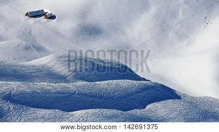 Hills covered by powder snow. Ski and snowboard tracks. Winter scene in the Stoos ski area Swiss Alps.