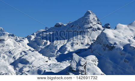 View from Chlingenstock Swiss Alps. Snow covered mountain.