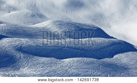 Hills covered with ski and snowboard tracks. Powder snow. Scene in the Stoos ski area.