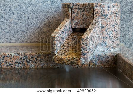 Close up section of onsen marble bathtub and marble faucet Japanese style bath