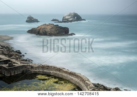 Foggy Ruins of Sutro Baths, San Francisco, California, USA. Dramatic misty fog over Sutro Bath historical landmark in San Francisco.