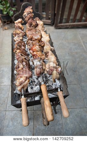 Traditional Cypriot food chicken pork lamb chicken in big pieces cooked on charcoal.