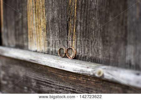 Two wedding rings on gray wood background. Soft focus. Vintage filter.