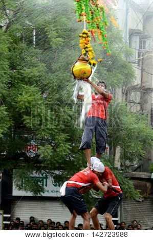 AMRAVATI, MAHARASHTRA, INDIA - AUGUST 29 : Crowd of young People enjoying "Govinda" the Dahi Handi festival to celebrate God Krishna's Birth in Amravati, Maharashtra, India. 29 August 2013