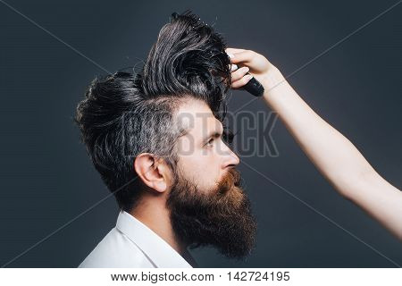 Female Hand Combing Bearded Man