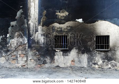 Old weathered wall background painted. Paint spilled. Iron barred windows
