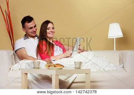 Young Couple With Tablet And Credit Card At Home