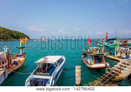 Koh Larn, Thailand - July 02, 2016: Colorful Fishing Boats and speed boat in Koh Larn Harbor
