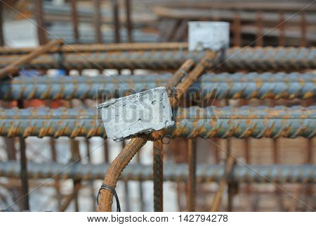 SELANGOR, MALAYSIA -SEPTEMBER 19, 2015: Hot rolled deformed steel bars or steel reinforcement bar and the concrete spacer. The spacer used to created gap between reinforcement bar and the form work.