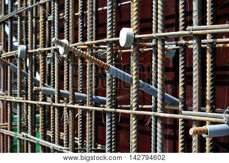 SELANGOR, MALAYSIA -SEPTEMBER 19, 2015: Hot rolled deformed steel bars or steel reinforcement bar and the concrete spacer. The spacer used to created gap between reinforcement bar and the form work.