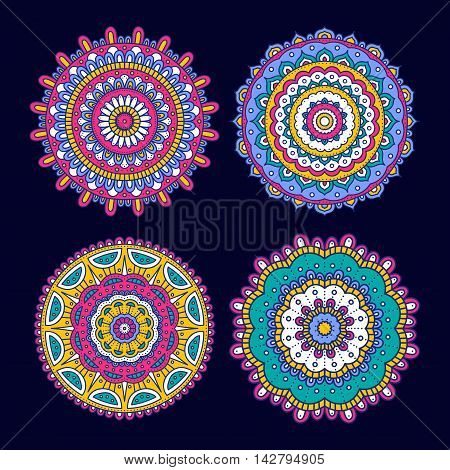 Set of colorful doodle mandalas. Circle lace ornament. Vector hand drawn ethnic floral pattern. Abstract tribal flowers set. Bright elements on dark blue background.
