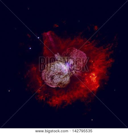 The Homunculus Nebula is a bipolar emission and reflection nebula surrounding the massive star system Eta Carinae. Retouched colored image. Elements of this image furnished by NASA.