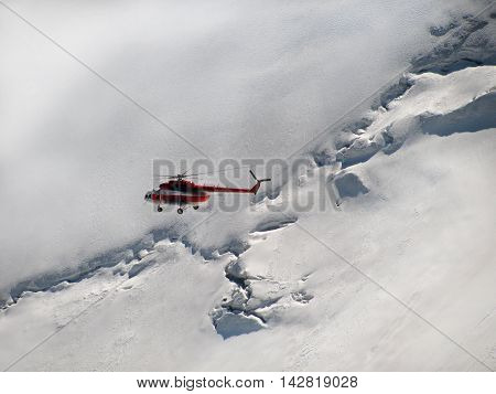 Helicopter flying in the background of snowy mountains