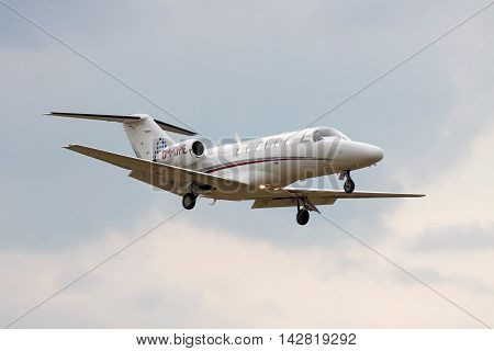 Kiev Ukraine - July 31 2012: Cessna 525A CitationJet CJ2 business jet is landing with cloudy sky on the background