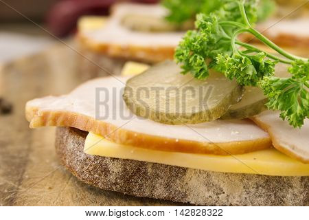Sandwich With Meat And Chease On Cutting Board. Soft Focus