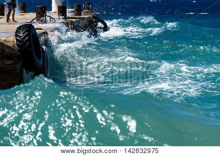 Strong Winds And Waves Are Hitting A Pier In Harbor. Port In Silba