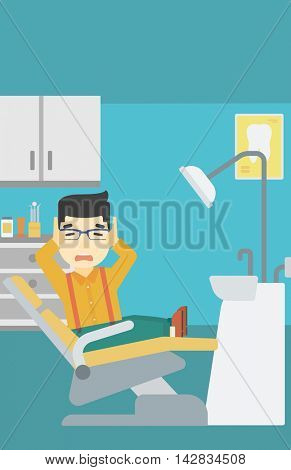 An asian young frightened patient at dentist office. Scared young man in dental clinic. Afraid man sitting in dental chair. Vector flat design illustration. Vertical layout.