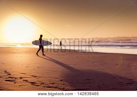 Beautiful beach lansdscape with surfers ready to hit the waves