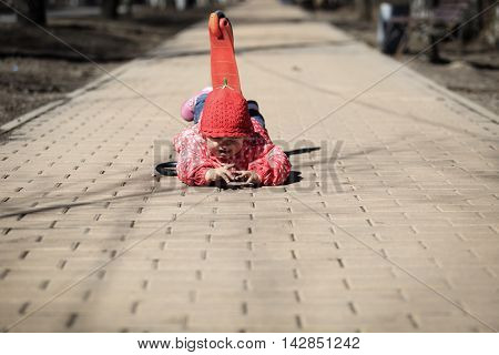little girl fall off of scooter, kids safety concept