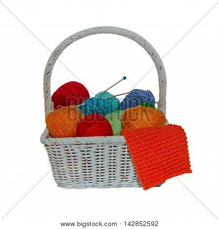 Wool basket with knitting needles isolated on background