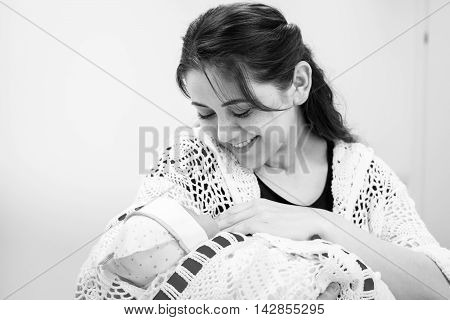 Young Mother Looking At Newborn Daughter.black And White Photography