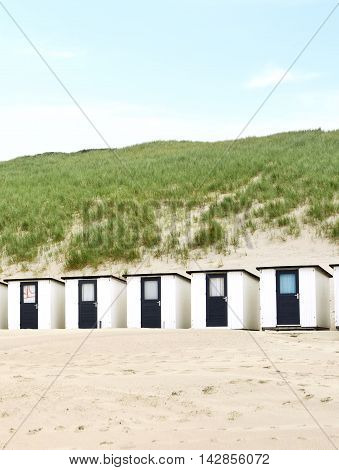 beach huts or houses and clear sky. Beach huts in front of a beach dune.
