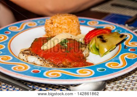 On A Plate Decorated With Mexican Rice, Bell Pepper And Grilled Steak With Sauce