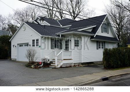 WEQUETONSING, MICHIGAN / UNITED STATES - DECEMBER 22, 2015: A white home with an attached garage on Pennsylvania Avenue in Wequetonsing, Michigan.