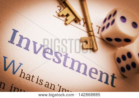 Vintage / retro color style : Two brass keys and dices on a fundamental investment document. A concept of key success in investment that need some basic knowledge otherwise it would be a gambling.