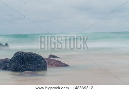 moss on the giant rock with motion of sea