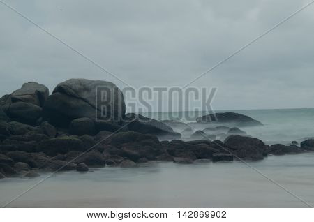 moss on the giant rock with motion of sea