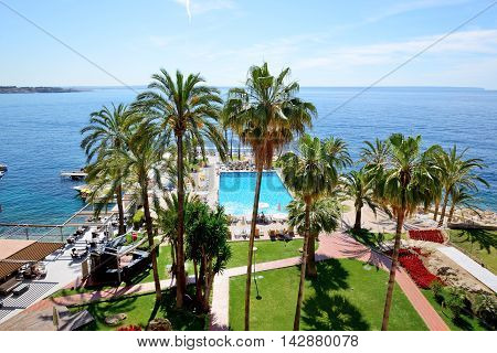 MALLORCA SPAIN - MAY 29: The tourists enjoiying their vacation on the beach on May 29 2015 in Mallorca Spain. Up to 60 mln tourists is expected to visit Spain in year 2015.