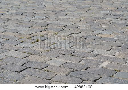 Geometry pattern of cobblestone pavement cladding with moss between stones