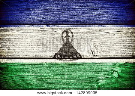 flag of Lesotho painted on old grungy wooden background: 3d illustration