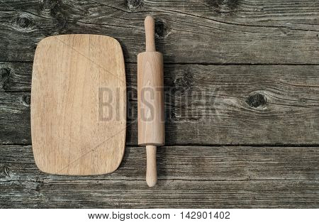 Cutting board on rustic wooden background. Top view