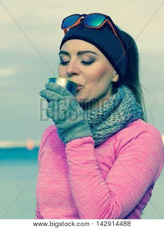 Fit Woman In Cold Day Warming Up Drink Tea