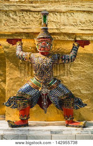 BANGKOK THAILAND - MARCH 9 2016: Thai colorful giant statue around Golden Chedi at Wat Phra Kaew in Bangkok Thailand.