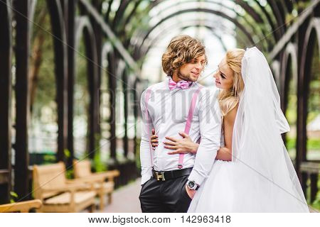 Elegant bride and groom posing together outdoors on a wedding day