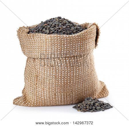 black beluga lentils in burlap bag with heap near isolated on white background. Black beluga lentils. Super food