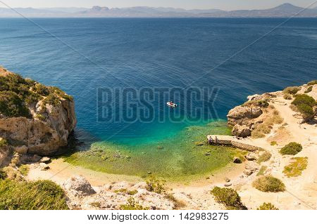 Perachora Ireon lake in Greece with beautiful green water and a fast boat in it.