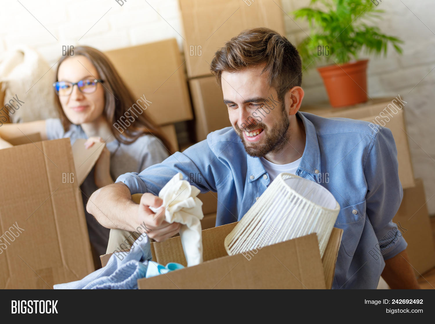 Cheerful Man Image Photo Free Trial Stock Cheerful Man And Unng Stuff From Carton Boxes In New Apartment Having Fun