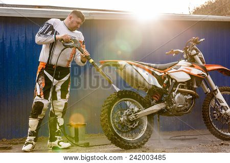 Biker A Man Cleaning Motorcycle From A High Pressure Washer