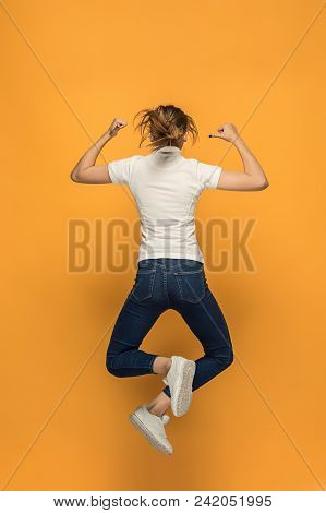 Closeup Back Of Young Jumping Woman In Empty White T-shirt On Orange Background. Clothing, Mock Up F