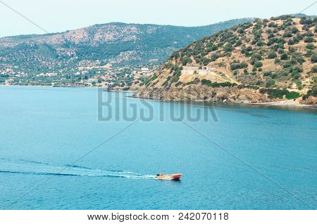 Small Motor Boat Sails Along The Shore. The Island Of Salamina.greece. Concept- Vacation, Tourism, T