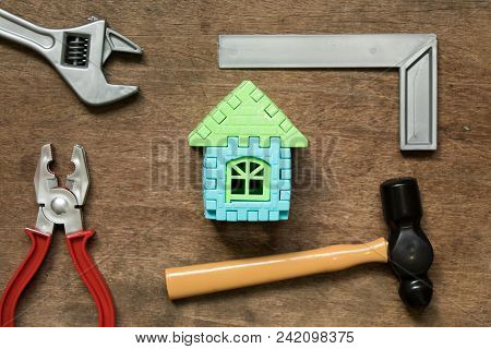 Home Model Object With Toy Equipment Tool On Wood Background (concept For Home Repair Or Fix)