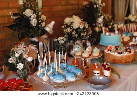 Candy Bar. Delicious Sweet Buffet With Cupcakes. Sweet Holiday Buffet With Cupcakes And Other Desser