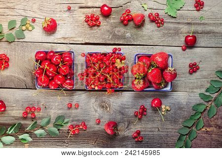 Top View Fresh Summer Berries - Strawberry, Cherry And Red Current In Ceramic Bowls On The Rustic Wo