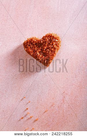 Hawaiian Red Gold Salt, in heart shape on rose marble background