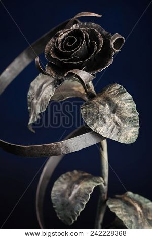 The Broze Rose With A Tape Made Of Metal, On Black Background.