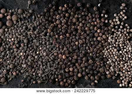 Variety Of Different Black Peppers Allspice, Pimento, Monks Pepper, Peppercorns Over Old Black Iron 